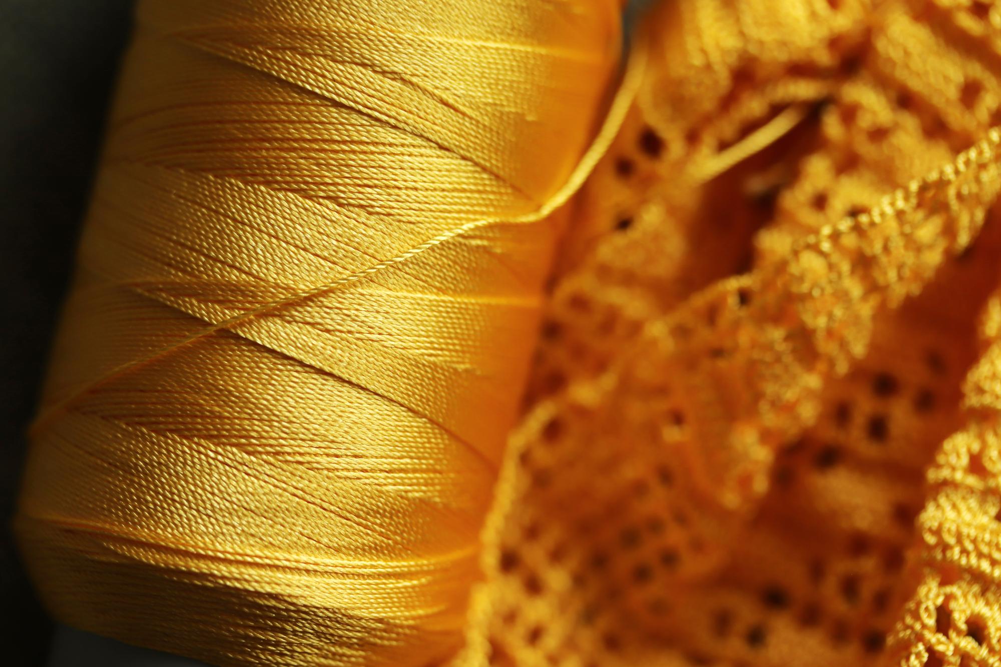 Close-up of embroidered textile with gold thread